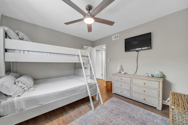 bedroom with ceiling fan and dark hardwood / wood-style flooring