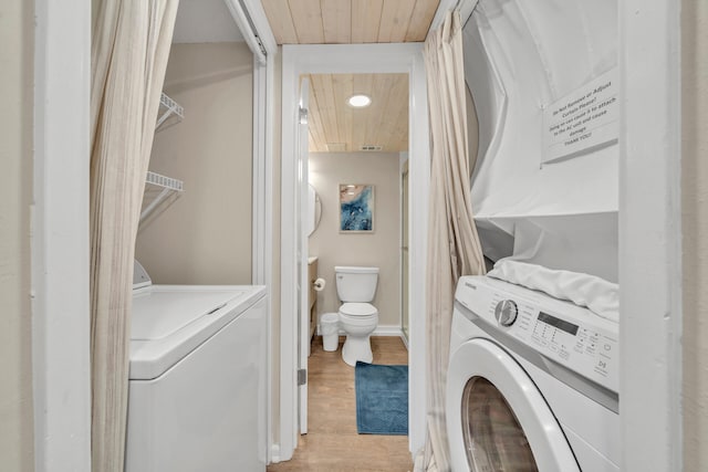 laundry area with washing machine and clothes dryer, wood ceiling, and light wood-type flooring