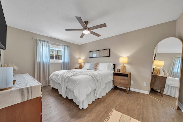 bedroom with ceiling fan and hardwood / wood-style floors