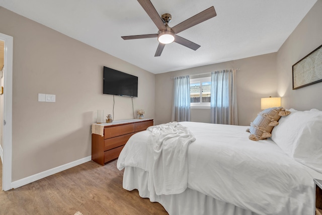 bedroom with ceiling fan and light wood-type flooring