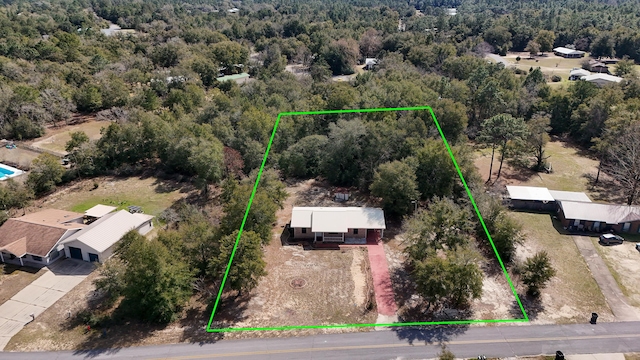 drone / aerial view featuring a forest view