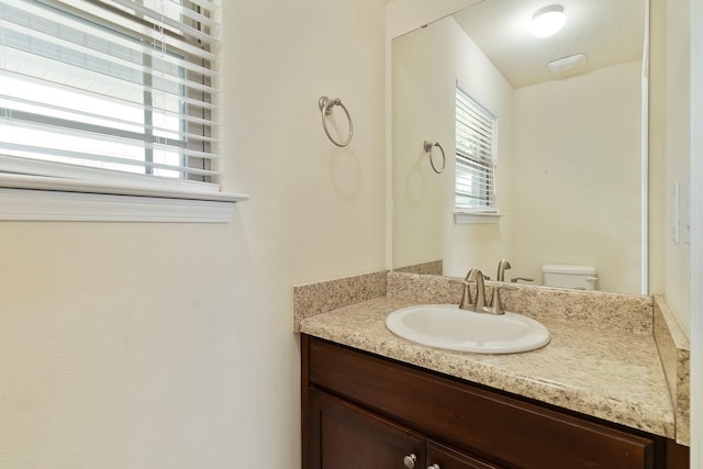 bathroom featuring vanity and toilet