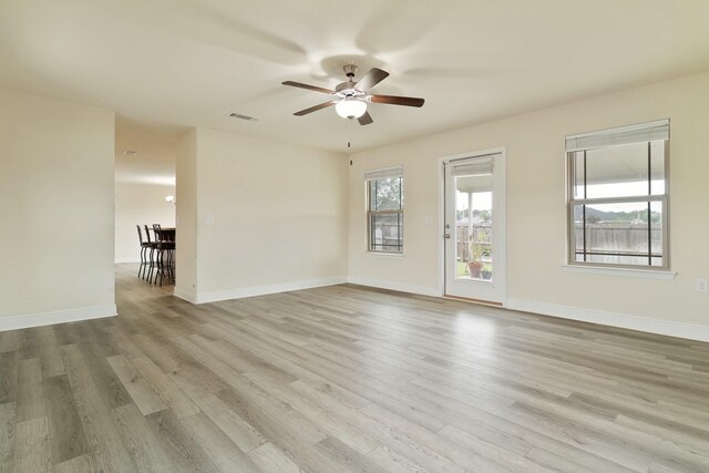 empty room featuring ceiling fan and light hardwood / wood-style floors