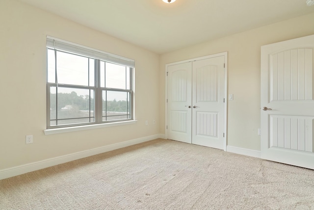 unfurnished bedroom with a closet and carpet floors