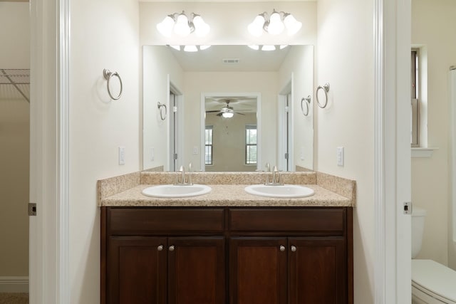 bathroom with ceiling fan, vanity, and toilet