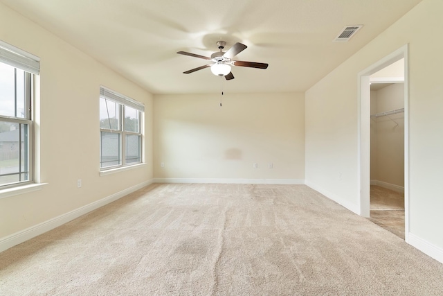 carpeted spare room with ceiling fan