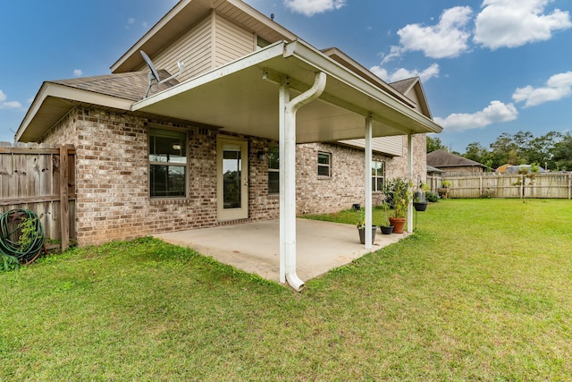 rear view of property with a patio area and a yard