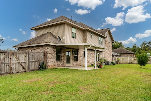 back of property with a lawn, central AC unit, and a patio