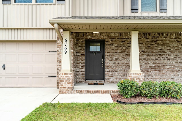 property entrance featuring covered porch and a garage