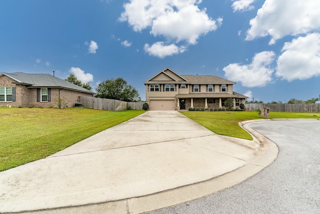 view of front facade with a garage and a front lawn