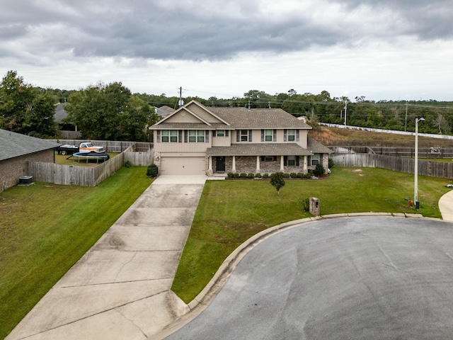 view of front facade featuring a garage and a front lawn