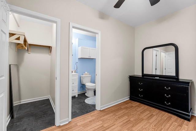 bedroom with light hardwood / wood-style floors, ensuite bath, and ceiling fan