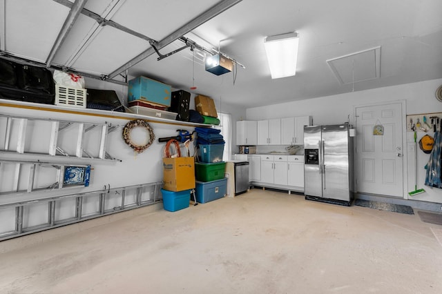 garage featuring stainless steel fridge with ice dispenser and a garage door opener