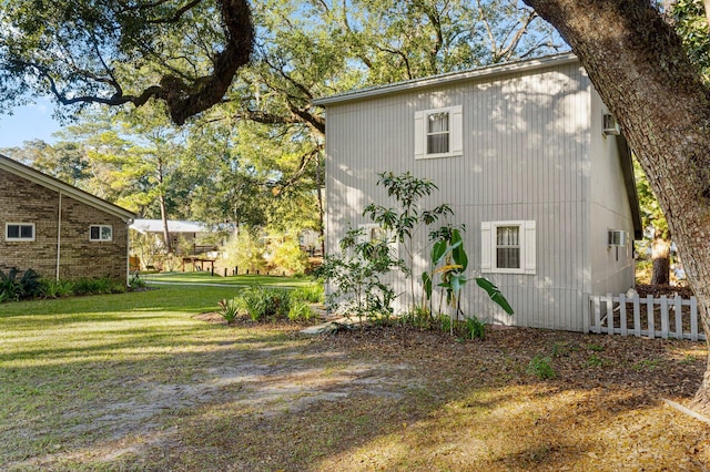 view of side of home with a lawn