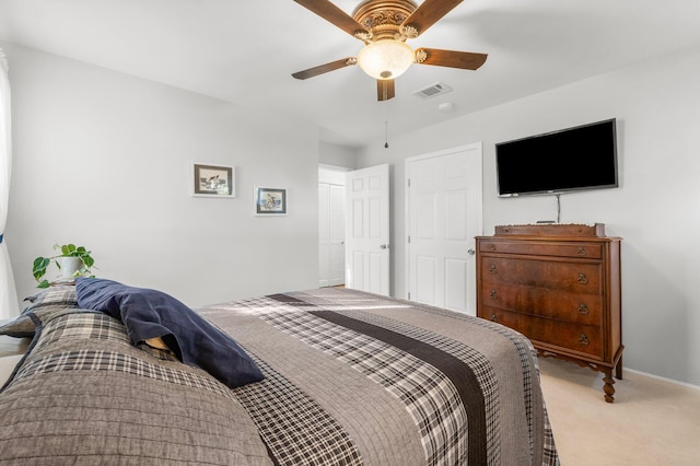 bedroom featuring ceiling fan and light carpet