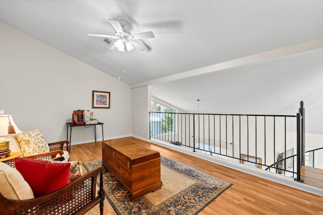 sitting room with hardwood / wood-style flooring, ceiling fan, and lofted ceiling