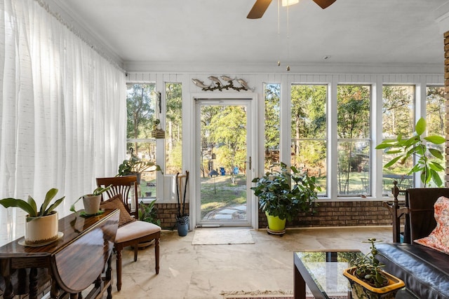 sunroom / solarium with a wealth of natural light and ceiling fan