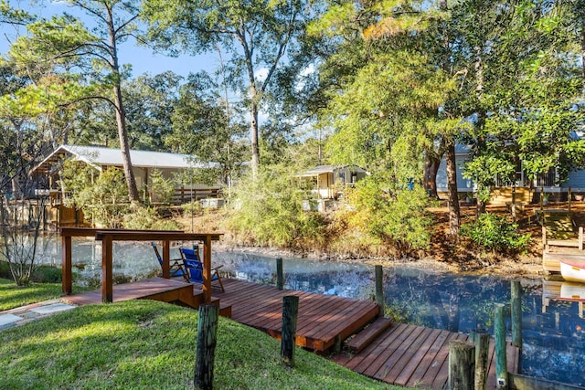 dock area featuring a water view and a yard