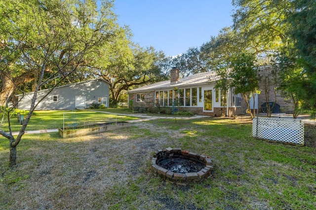 view of yard with a fire pit