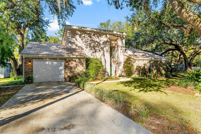 view of front of house featuring a garage and a front lawn