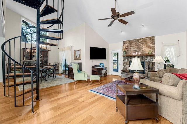 living room featuring a brick fireplace, ceiling fan, high vaulted ceiling, and hardwood / wood-style flooring