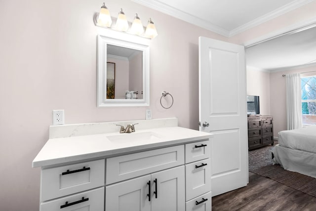 bathroom featuring hardwood / wood-style floors, vanity, and crown molding