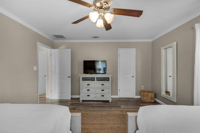 bedroom with ceiling fan, ornamental molding, and dark wood-type flooring