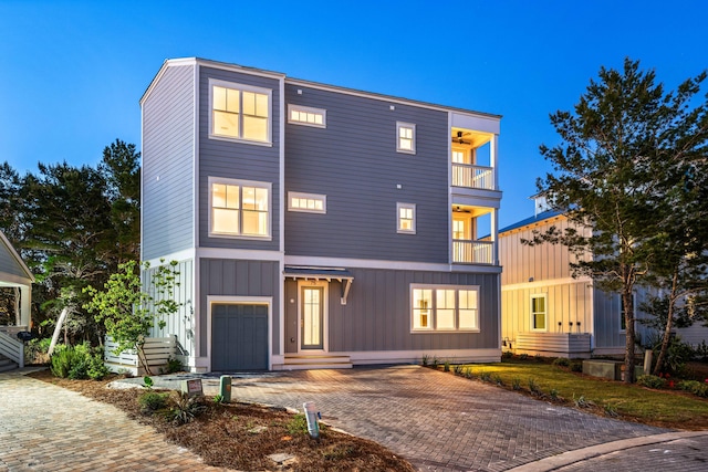 contemporary home featuring a balcony and a garage