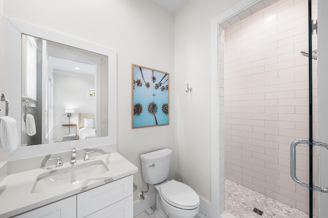 bathroom with vanity, a shower with shower door, and toilet