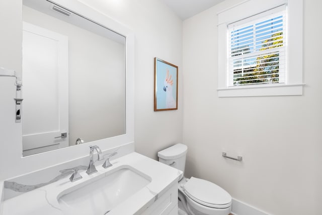 bathroom featuring vanity and toilet