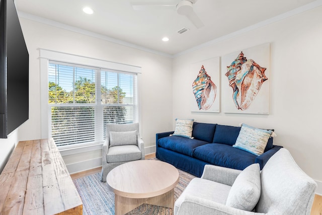 living room featuring a wealth of natural light, ceiling fan, wood-type flooring, and ornamental molding