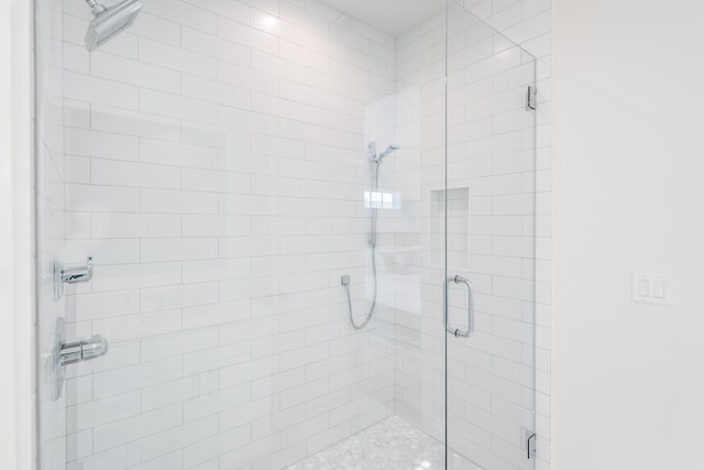 bathroom with a shower with shower door