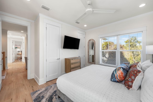 bedroom featuring ceiling fan, light wood-type flooring, and ornamental molding