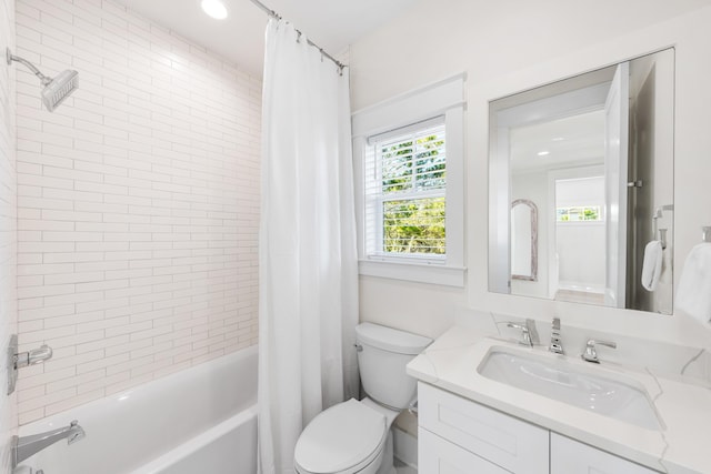 full bathroom featuring vanity, shower / bath combo, and toilet