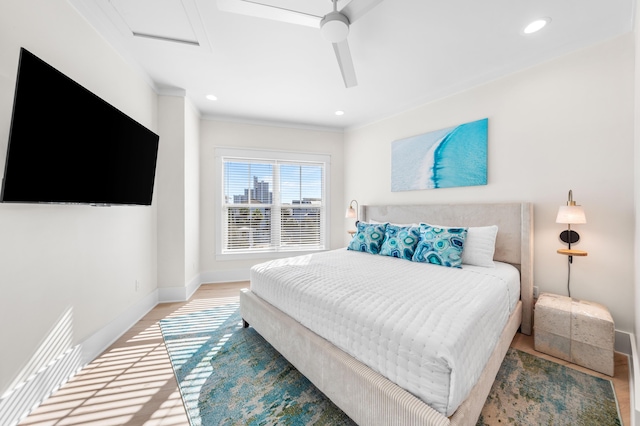 bedroom featuring hardwood / wood-style floors, ceiling fan, and crown molding