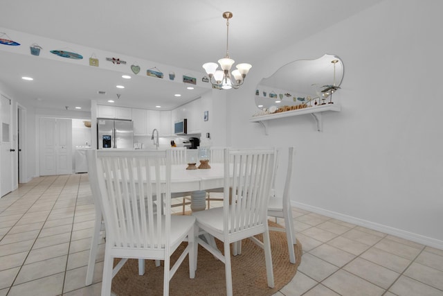 tiled dining area with sink and an inviting chandelier