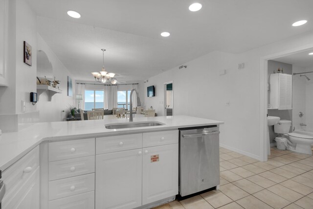 kitchen featuring dishwasher, sink, kitchen peninsula, decorative light fixtures, and white cabinets