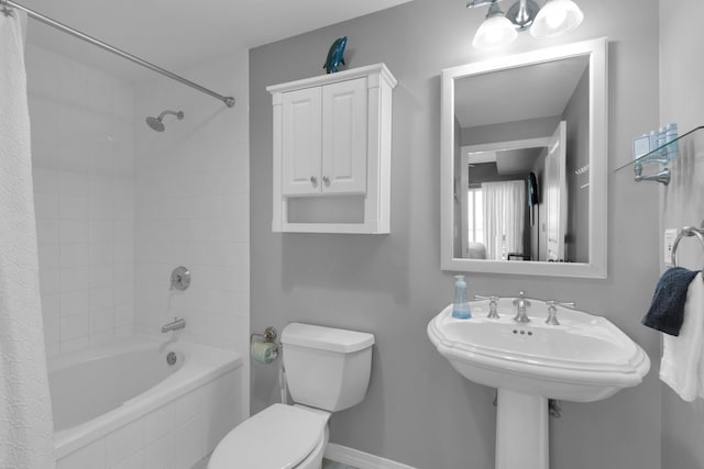 bathroom with shower / bath combo and toilet