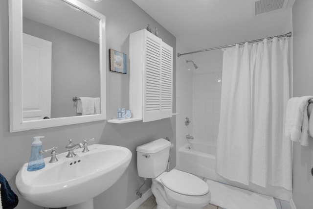 full bathroom with tile patterned flooring, shower / bath combo, toilet, and sink