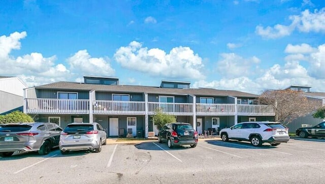 view of building exterior featuring uncovered parking
