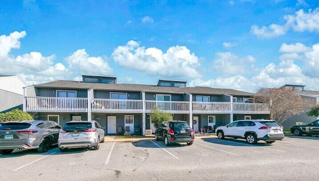 view of building exterior with uncovered parking