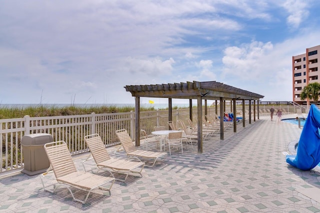 view of patio with a pergola and a community pool