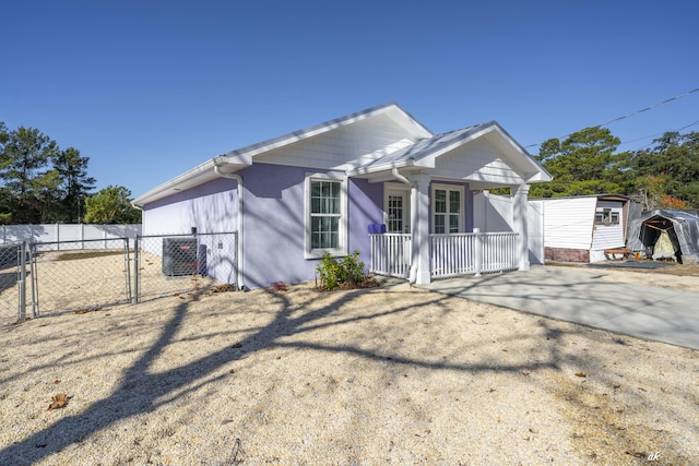 view of front of property with cooling unit and covered porch