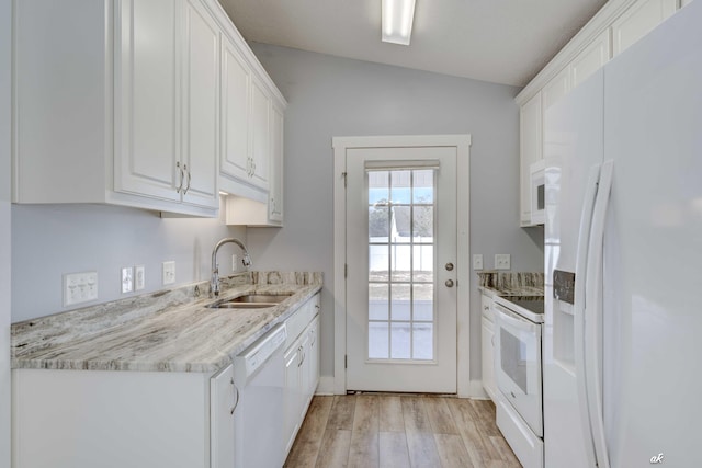 kitchen featuring white appliances, vaulted ceiling, sink, light hardwood / wood-style flooring, and white cabinetry