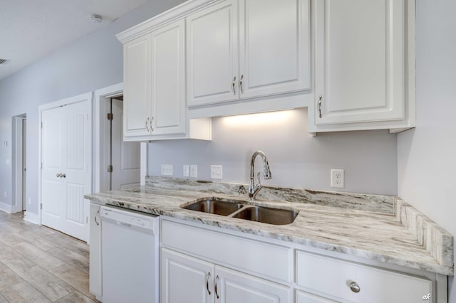 kitchen with white cabinets, dishwasher, and sink