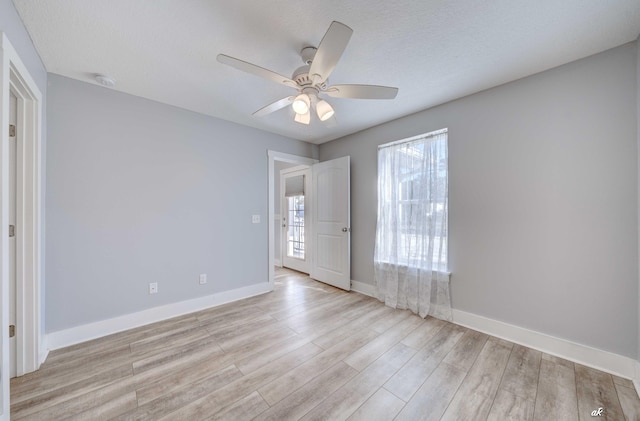 unfurnished bedroom with a textured ceiling, light hardwood / wood-style floors, and ceiling fan