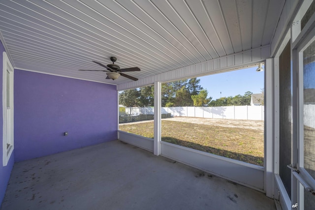 unfurnished sunroom featuring ceiling fan