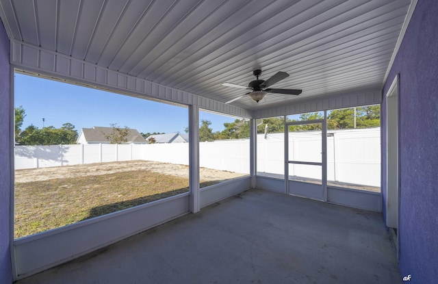 unfurnished sunroom with ceiling fan and a healthy amount of sunlight