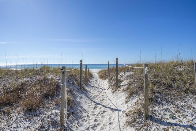 view of home's community with a beach view and a water view