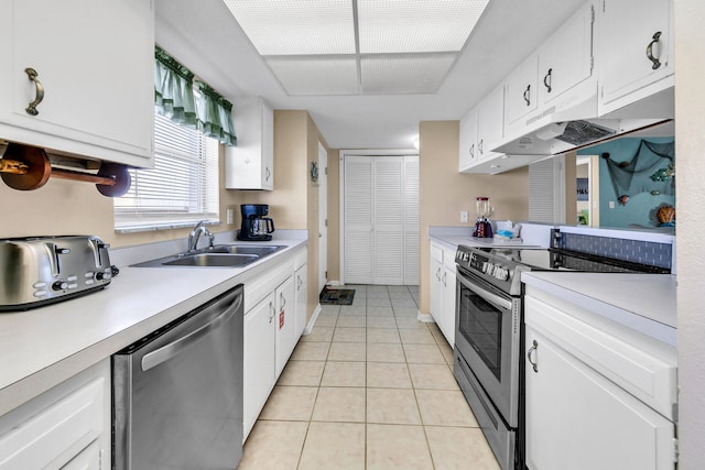 kitchen featuring white cabinets, light tile patterned flooring, sink, and appliances with stainless steel finishes